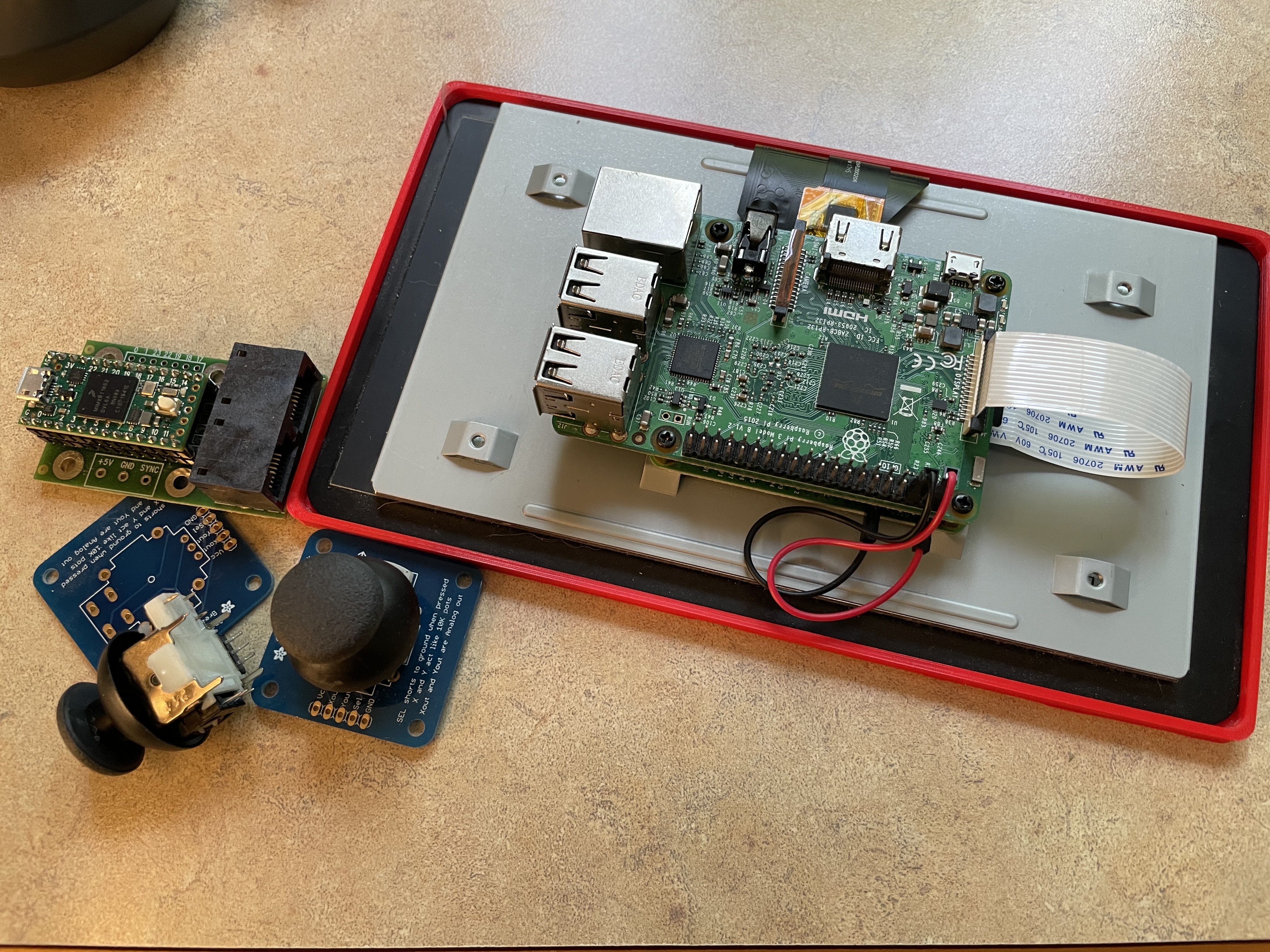 A Raspberry Pi attached to a screen and a few joystick components.