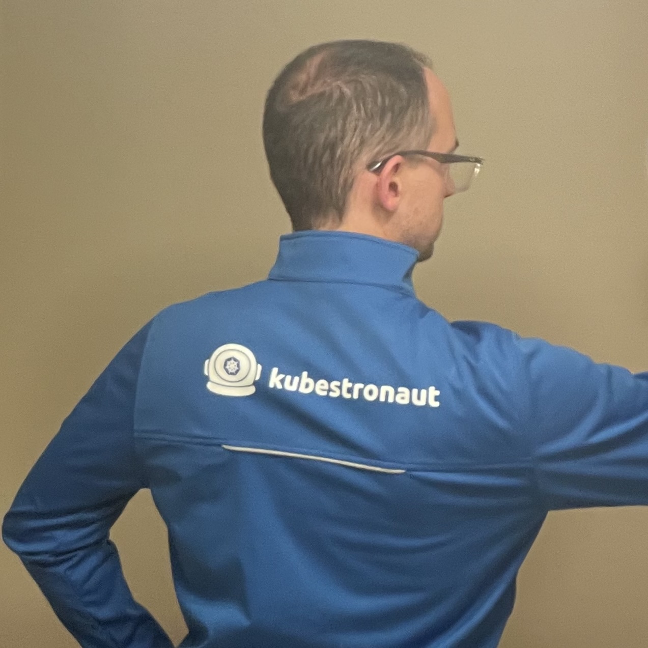 The author wearing a blue jacket with "Kubestronaut" across the back.