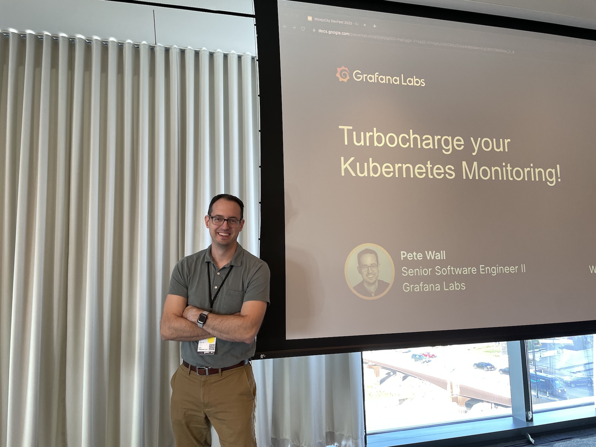 Pete onstage at Windy City DevFest 2023 in front of the &ldquo;Turbocharge your Kubernetes Monitoring!&rdquo; title slide