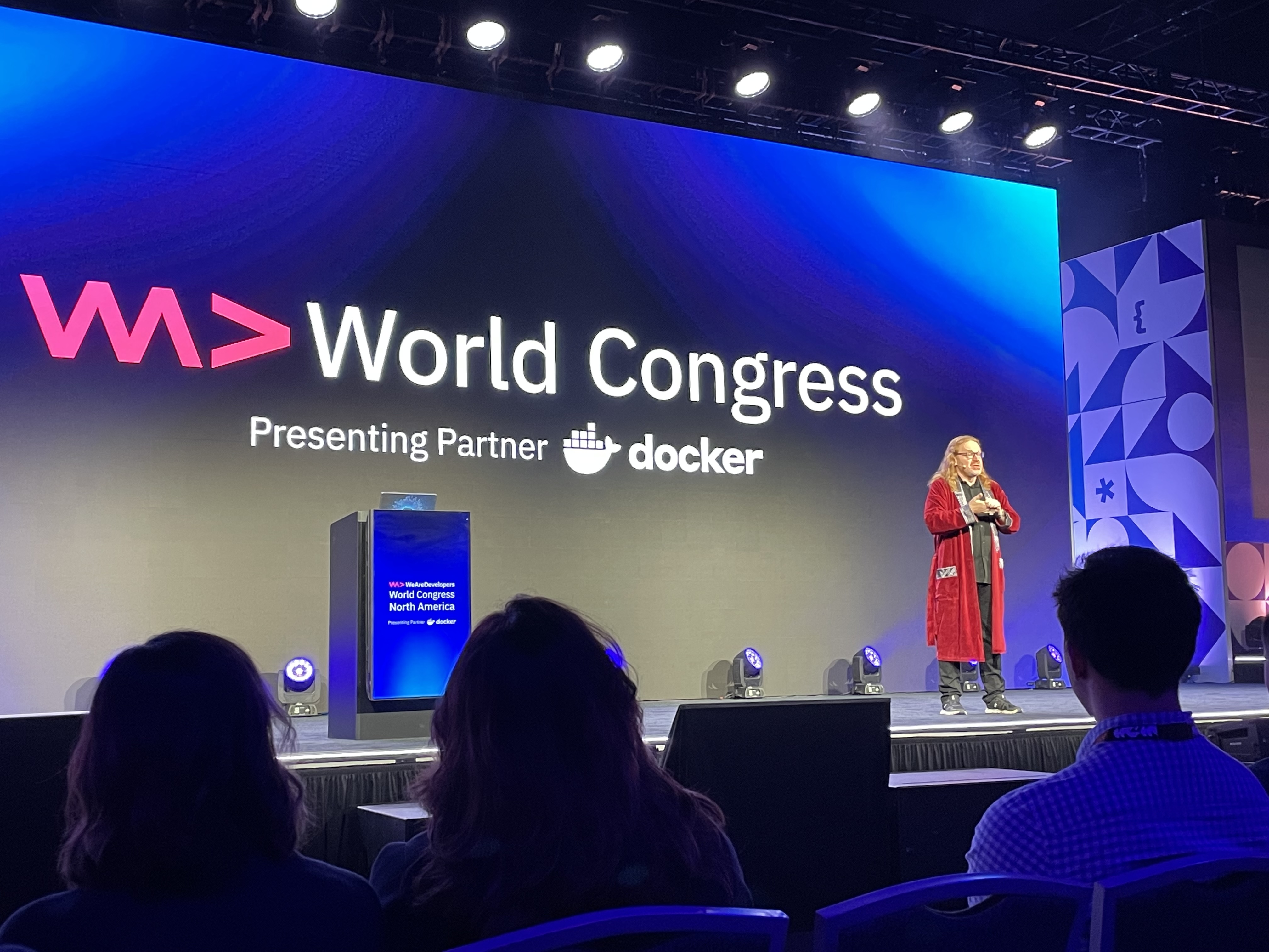 Chris Heilmann from WeAreDevelopers on the mainstage wearing a robe.